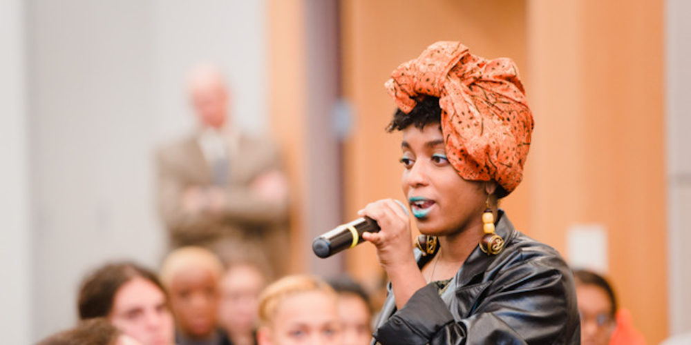 Audience member at Dedication Day asking a question.