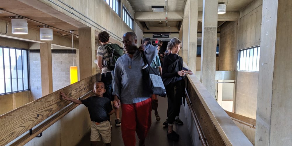 Audience walking through Hill Hall for Resounding the Tower. 6.30.2019